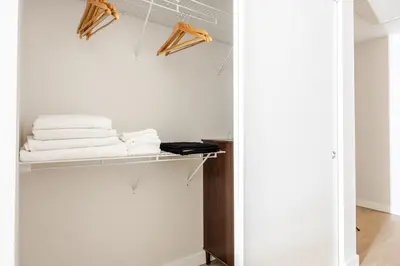 a closet with white towels on a shelf at Blueground Downtown elevator nr parks LAX-1245 in Los Angeles