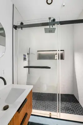 a glass shower in a bathroom with a sink at THE Cabin in Running Springs