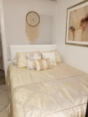 a white bed with pillows on it in a room at Studio in Southbay close to the beach SoFi stadium LAX in Lawndale