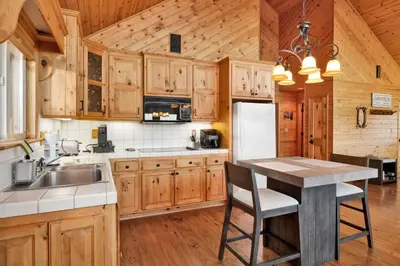 a kitchen with wooden cabinets and a white refrigerator at High-Top Lakeview Chateau #2520 in Fawnskin