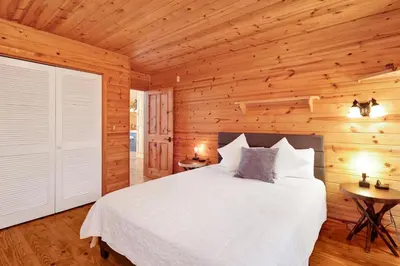 a bedroom with a bed in a wooden cabin at High-Top Lakeview Chateau #2520 in Fawnskin