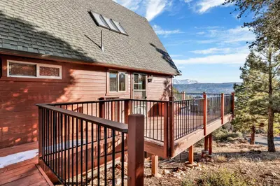 a home with a wooden deck next to a house at High-Top Lakeview Chateau #2520 in Fawnskin
