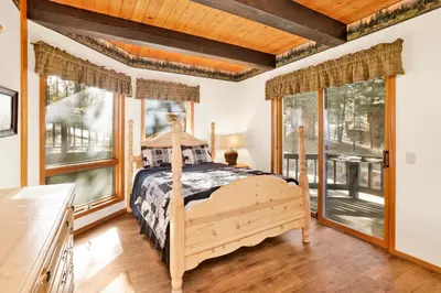 a bedroom with a bed and large windows at The Birdhouse #2529 in Big Bear Lake