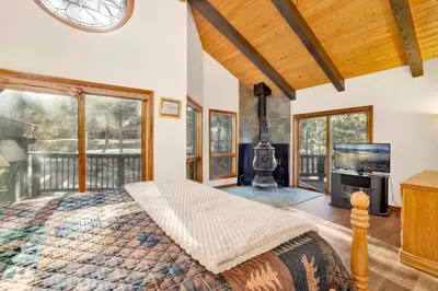 a bedroom with a large bed and a tv in it at The Birdhouse #2529 in Big Bear Lake