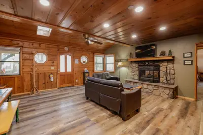 a living room with a couch and a fireplace at Kelley's Kabin #290 in Big Bear Lake