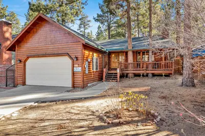 a log home with a garage and a deck at Oriole House #2518 in Big Bear Lake