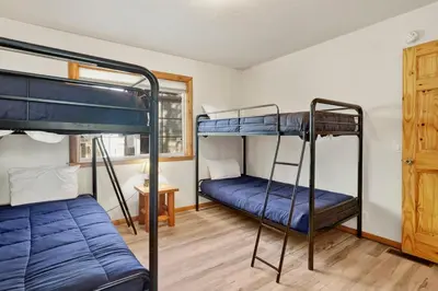 two bunk beds in a room with a window at Oriole House #2518 in Big Bear Lake