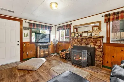 a living room with a fireplace and a tv at Green Squirrel Chateau #2484 in Big Bear Lake