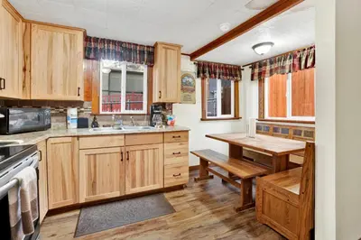 a kitchen with wooden cabinets and a wooden table at Green Squirrel Chateau #2484 in Big Bear Lake