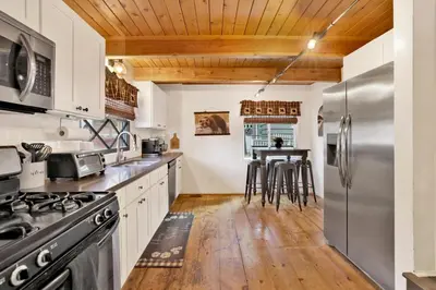 a kitchen with stainless steel appliances and wooden ceilings at Camp Conklin #2337 in Big Bear Lake