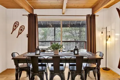 a dining room with a table and chairs and a window at Camp Conklin #2337 in Big Bear Lake