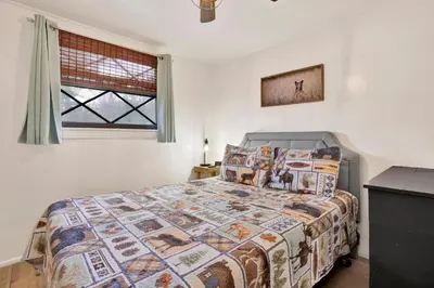 a bedroom with a bed and a window at Camp Conklin #2337 in Big Bear Lake