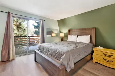 a bedroom with a bed and a large window at Aeroplane Gambrel #2509 in Big Bear City