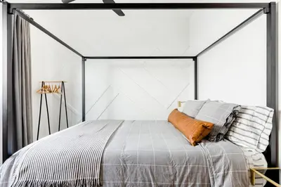a bedroom with a bed in a white room at Sleek Luxury Studio with Patio LAX & Beach Access in Los Angeles