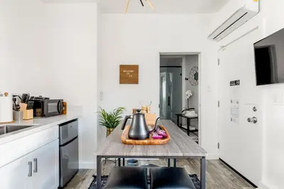 a kitchen with a table with a tea kettle on it at Sleek Luxury Studio with Patio LAX & Beach Access in Los Angeles