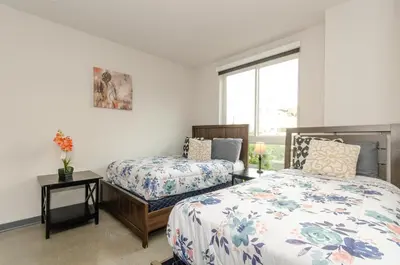 a bedroom with two beds and a window at Adorable 2bed Apt Balcony & Rooftop Pool D in Los Angeles