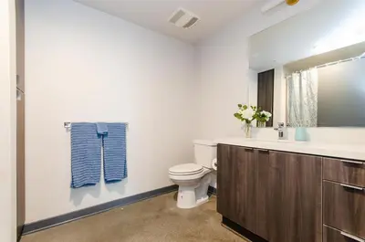 a bathroom with a toilet and a sink and a mirror at Adorable 2bed Apt Balcony & Rooftop Pool D in Los Angeles