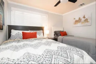 a bedroom with a large bed with red pillows at Charming 2BR Condo with Onsite Parking Included in Los Angeles