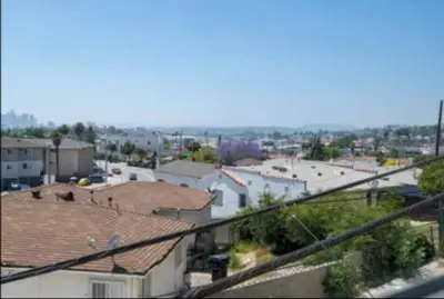 a view of a city with roofs and buildings at Charming 2BR Condo with Onsite Parking Included in Los Angeles