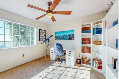a home office with a ceiling fan and a desk at Tree-mendous Skypark-View Cabin in Skyforest