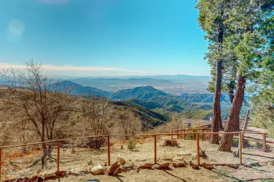 a view of the mountains from a hill with a fence at Tree-mendous Skypark-View Cabin in Skyforest