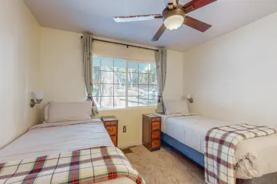 two beds in a room with a window at Tree-mendous Skypark-View Cabin in Skyforest
