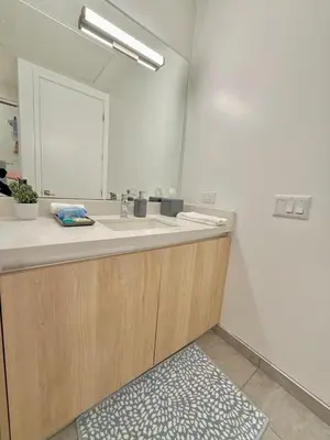 a bathroom with a sink and a mirror at Top Floor Hollywood 1BR Condo with Views in Los Angeles