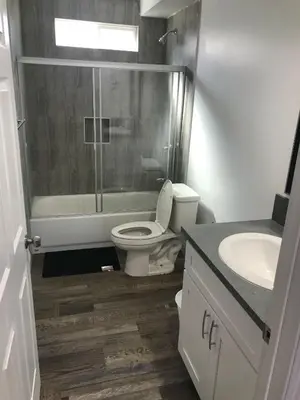 a bathroom with a toilet and a shower and a sink at VWM Hostel in Los Angeles