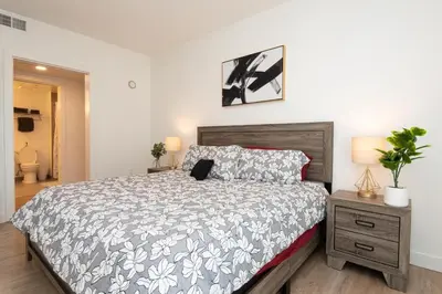 a bedroom with a bed with a laptop on it at Chic 3-bed Apt with Pool & Hot Tub in Heart of DTLA in Los Angeles