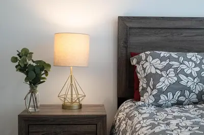 a bedroom with a bed and a lamp on a night stand at Chic 3-bed Apt with Pool & Hot Tub in Heart of DTLA in Los Angeles