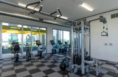a gym with a checkered floor and tread machines at Modern 3 Bedroom High-Rise with resort Pool in Los Angeles