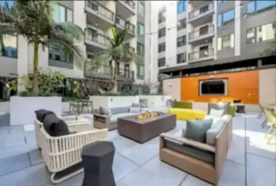 a patio with couches and chairs in a building at Stunning 3 Bedroom High-Rise with Pool, Spa, and Rooftop Views in Los Angeles
