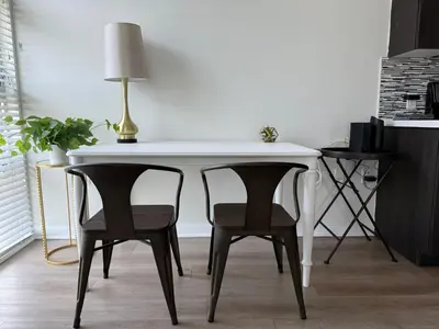 a white table with two chairs and a lamp on it at Studio Suite - Walk to Convention Center and Crypto Arena in Los Angeles