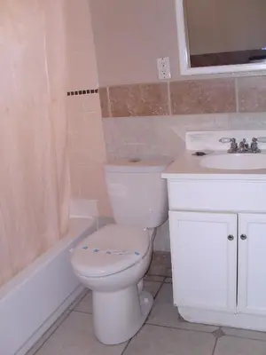 a bathroom with a white toilet and a sink at Budget Inn of Boron in Boron