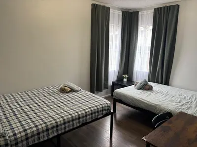 a bedroom with two beds and a window at The Disney Hostel - Fullerton - OC in Fullerton