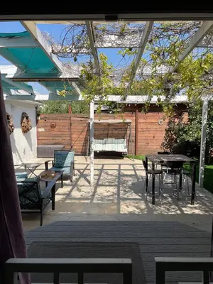a patio with tables and chairs and a pergola at Cozy and Relaxing in Suburbs of LA in Mission Hills