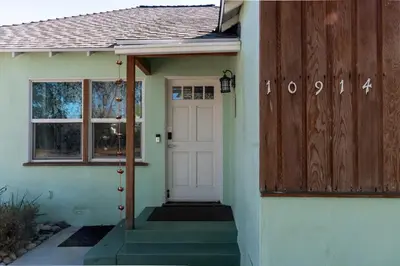 a house with a white door and a window at Cozy and Relaxing in Suburbs of LA in Mission Hills