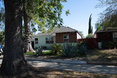 a house with a tree in front of it at Cozy and Relaxing in Suburbs of LA in Mission Hills