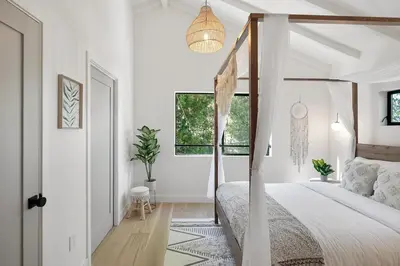 a bedroom with a canopy bed and a window at Studio City Stunning House with 5 bedrooms, Pool, Jacuzzi, Fire-pit, Guest House in Studio City