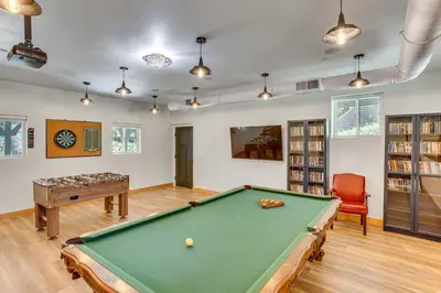 a room with a pool table and a book shelf at Game Room and Deck Pet-Friendly Lake Arrowhead Home in Lake Arrowhead