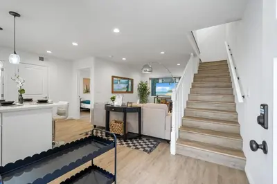 a living room and kitchen with a staircase in a house at NEW Koreatown l Universal Studios in Vernon