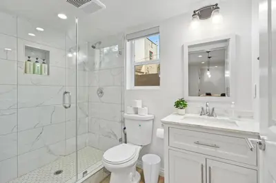 a white bathroom with a toilet and a shower at NEW Koreatown l Universal Studios in Vernon