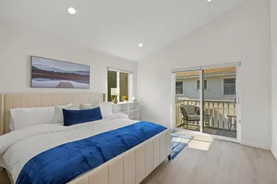 a bedroom with a large bed and a balcony at NEW Koreatown l Universal Studios in Vernon