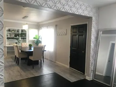 a dining room with a table and a mirror at 4bed 2ba Hollywood house Block away from sunset, Free parking, private backyard in Los Angeles