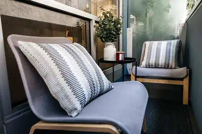 a pillow sitting on a chair in a room at Seaside Serenity - Chic Santa Monica Studio in Los Angeles