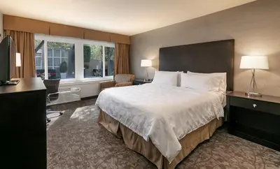 a hotel room with a large bed and a window at Pacific Stay Hotel in West Covina