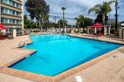 a large pool with blue water in a resort at Pacific Stay Hotel in West Covina
