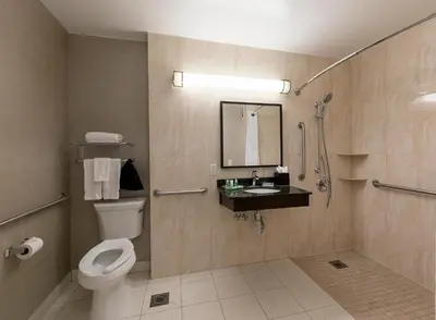 a bathroom with a toilet and a sink and a shower at Pacific Stay Hotel in West Covina