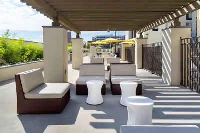 a row of chairs and tables on a patio at SpringHill Suites by Marriott Los Angeles Burbank/Downtown in Burbank
