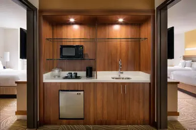 a hotel room with a sink and a tv at SpringHill Suites by Marriott Los Angeles Burbank/Downtown in Burbank